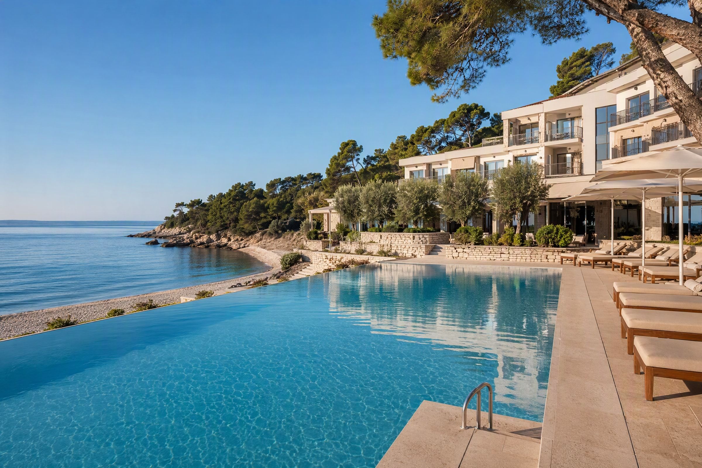 A hotel pool by the sea and beach